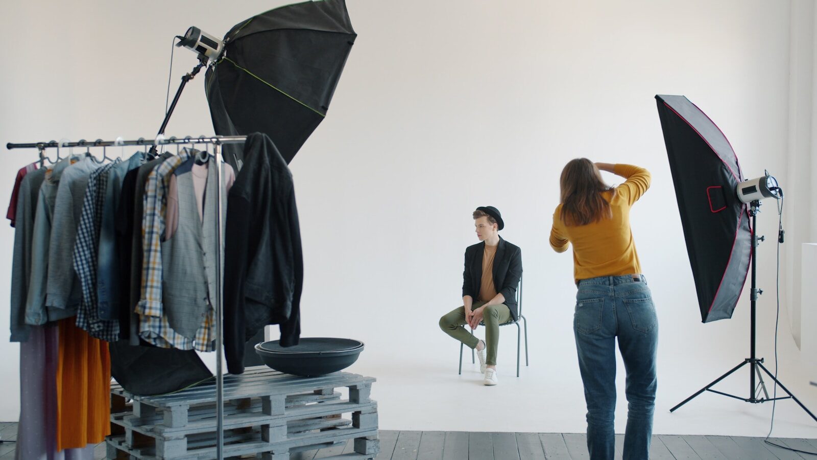 Photographer taking picture of model in studio